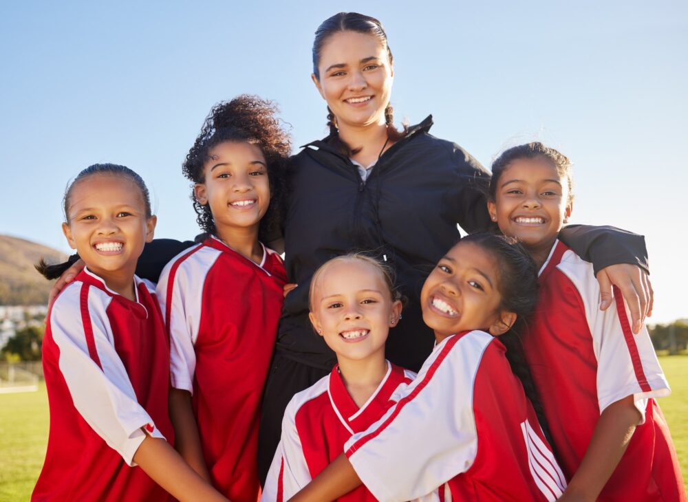 Football sports coach, girl and teamwork for motivation, support and exercise at competition, game