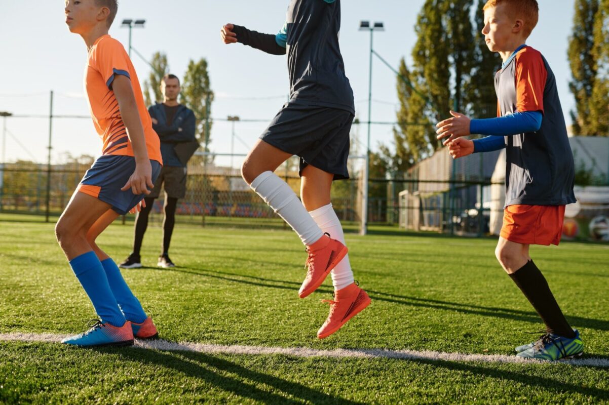 group-of-boys-running-on-green-football-field-during-training-class.jpg